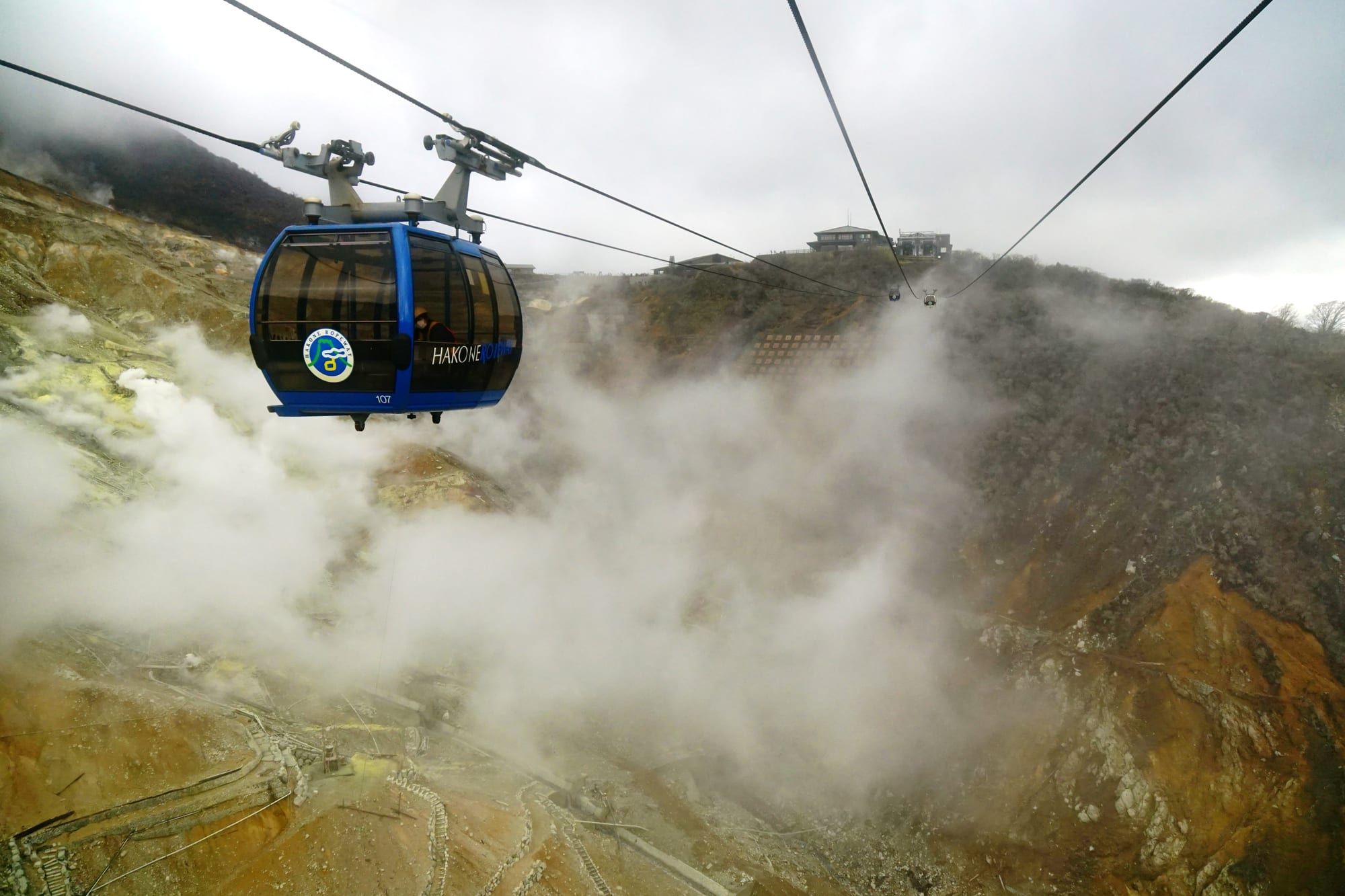 A Hakone Ropeway gondola above the steaming volcanic slopes of Owakudani