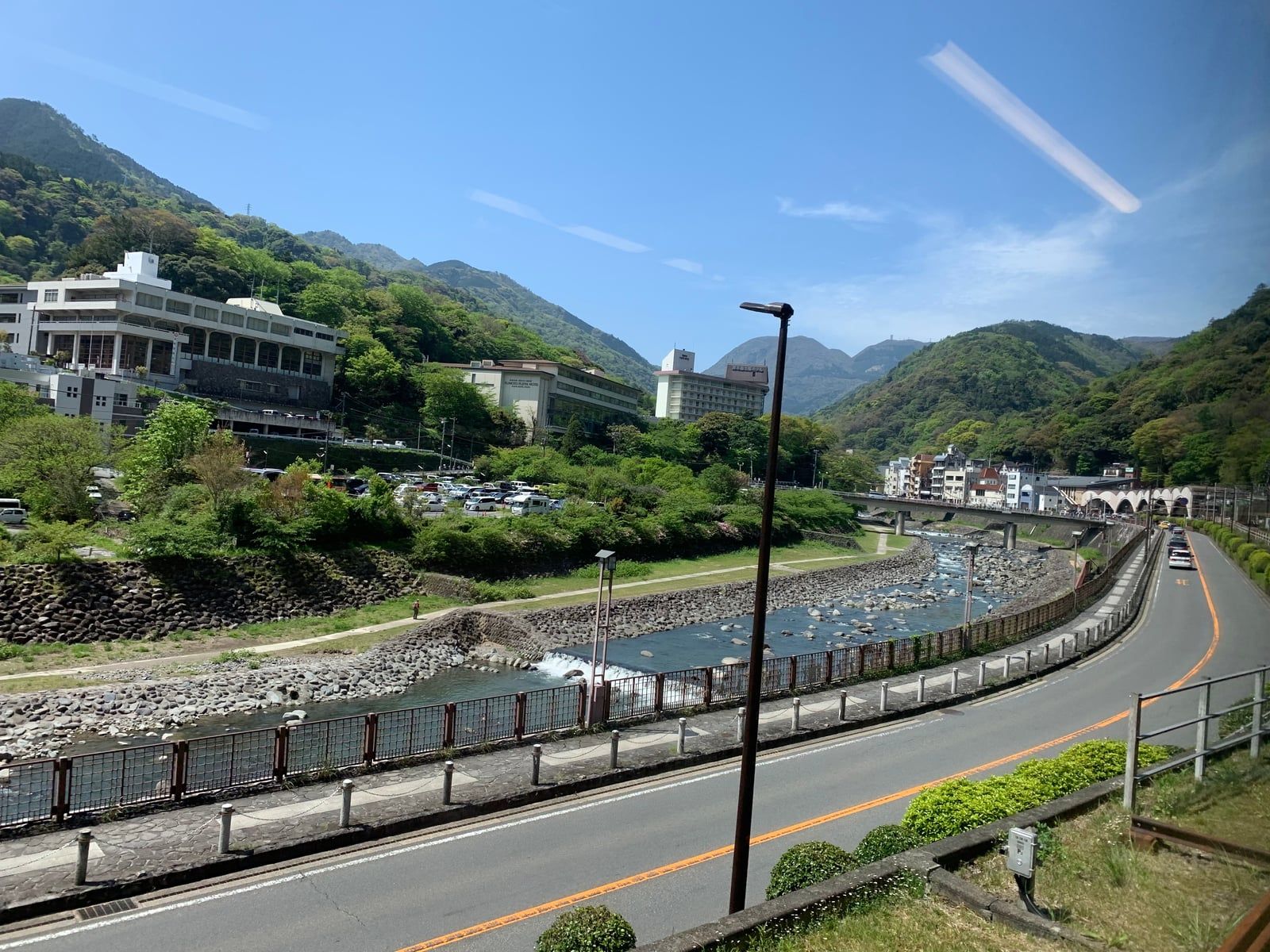 The Hayakawa River running past the buildings of Hakone-Yumoto, with green mountains behind