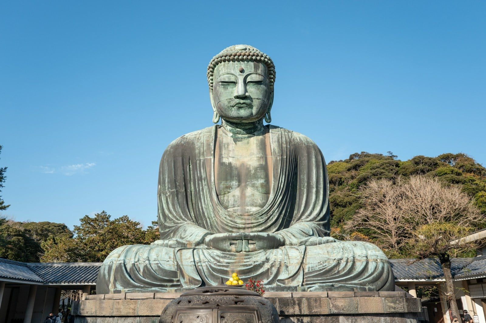 Front view of the Great Buddha of Kamakura at Kotoku-in under a clear blue sky